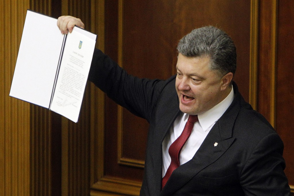 Ukraine's President Poroshenko shows a signed landmark association agreement with the European Union during a session of the parliament in Kiev
