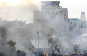 Smoke rises above Independence Square as clashes between anti-government protesters with Interior Ministry members and riot police continue in central Kiev